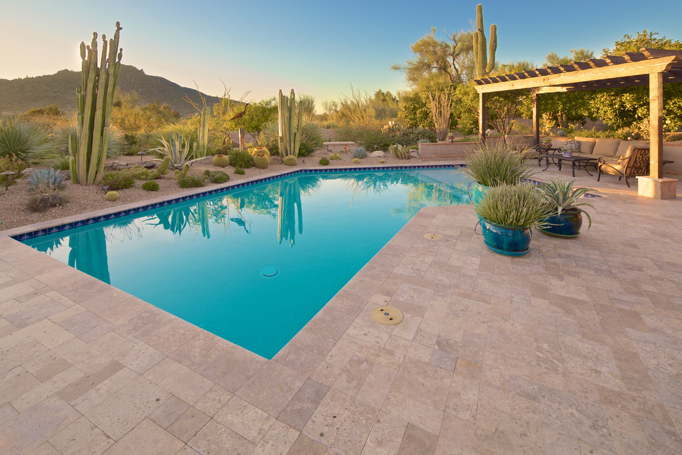 Inspiration for a large mediterranean back custom shaped natural swimming pool in Phoenix with concrete paving.