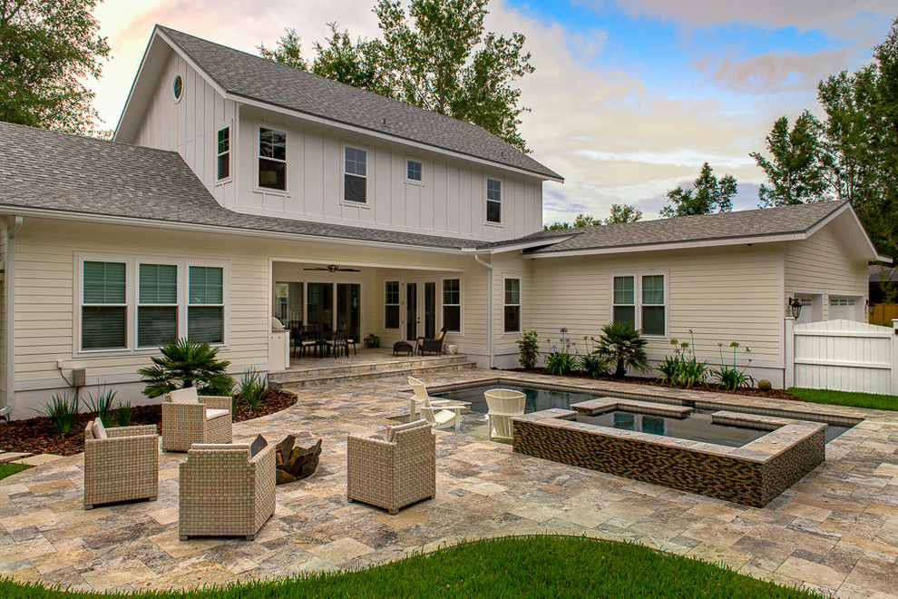 На фото: прямоугольный бассейн на заднем дворе в классическом стиле с покрытием из каменной брусчатки