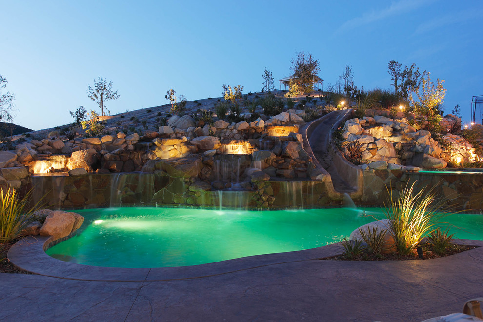 World-inspired custom shaped swimming pool in Los Angeles with a water slide.