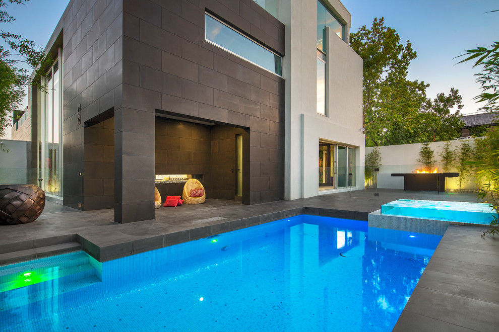 Inspiration for a medium sized contemporary back rectangular lengths hot tub in Melbourne with concrete paving.