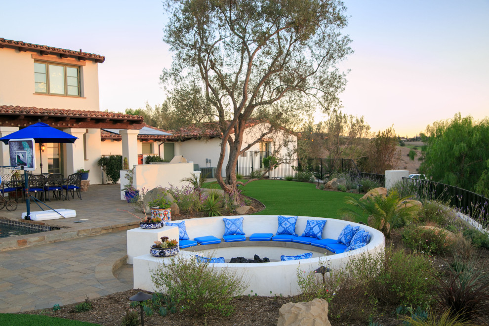 Design ideas for a large mediterranean back rectangular lengths swimming pool in San Diego with with pool landscaping and concrete paving.