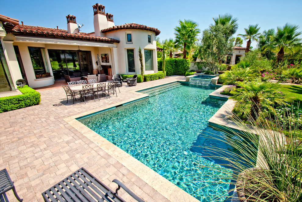 Inspiration for a mediterranean swimming pool in Los Angeles with brick paving.