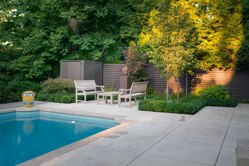 Inspiration for a mid-sized modern backyard stamped concrete and rectangular lap pool remodel in Toronto
