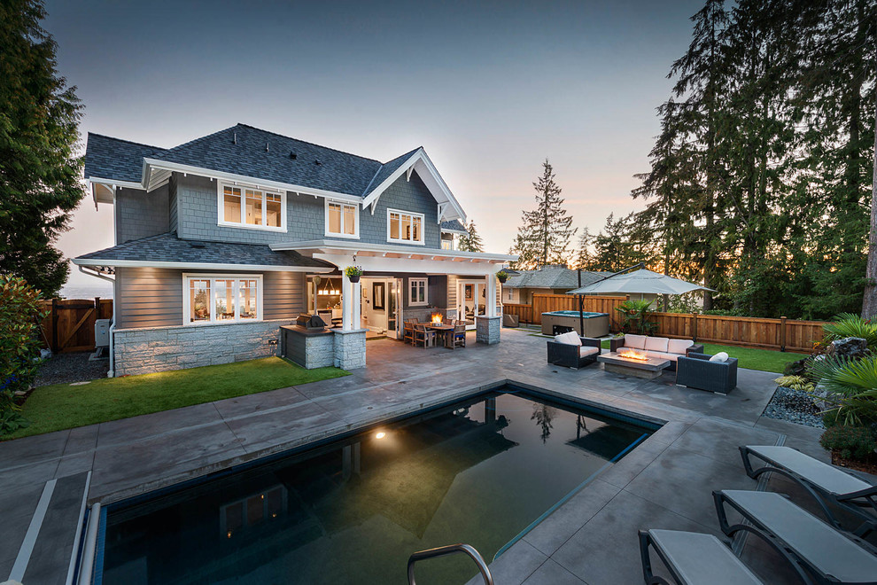 Inspiration for a large timeless backyard concrete paver and rectangular lap hot tub remodel in Vancouver