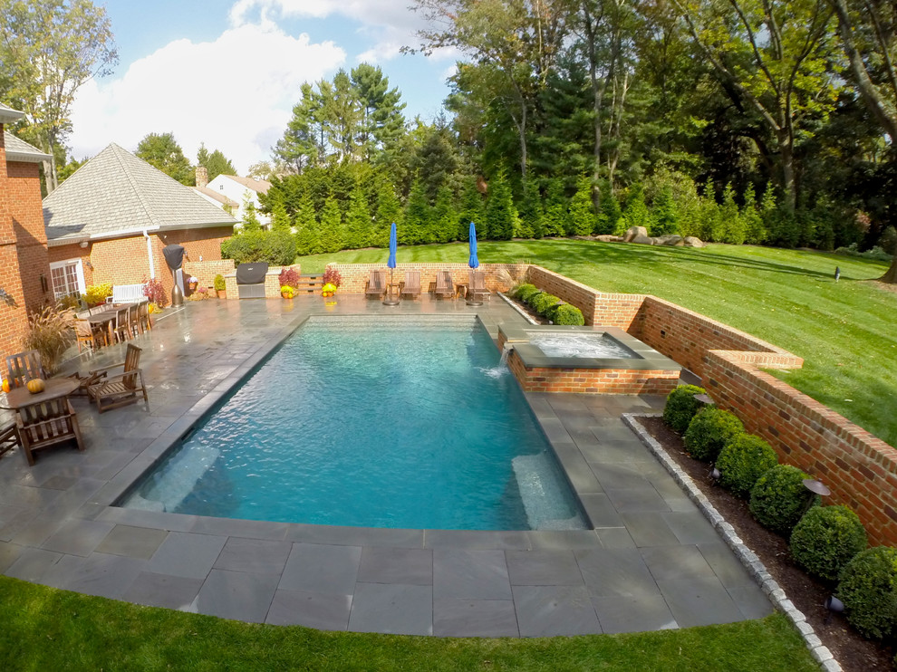 Inspiration for a medium sized traditional back rectangular hot tub in Philadelphia with natural stone paving.