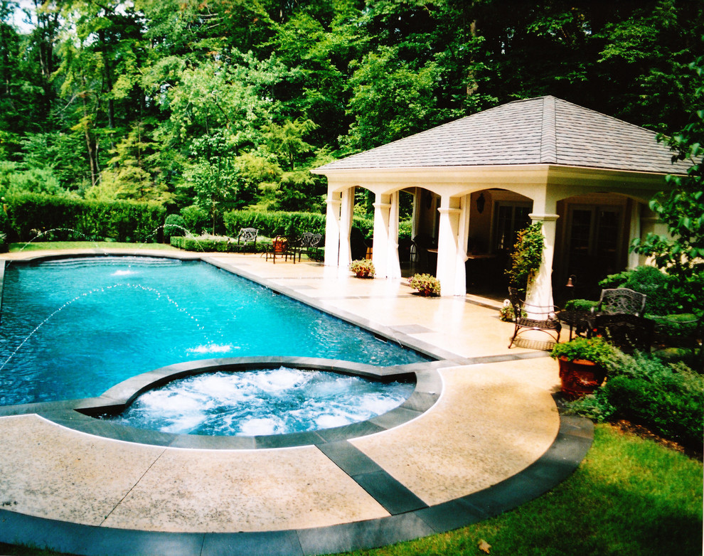 Inspiration for a large classic back custom shaped swimming pool in Philadelphia with a pool house and concrete slabs.