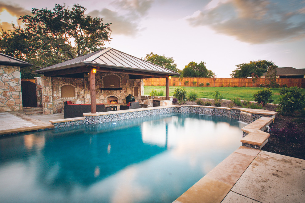 Large elegant backyard stone and custom-shaped lap pool house photo in Austin