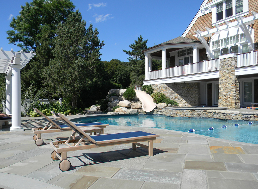 На фото: естественный бассейн среднего размера, произвольной формы на заднем дворе в классическом стиле с покрытием из каменной брусчатки и фонтаном с