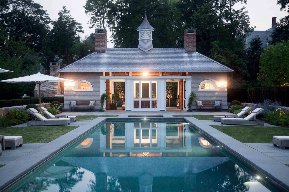 Classic rectangular swimming pool in New York with a pool house.