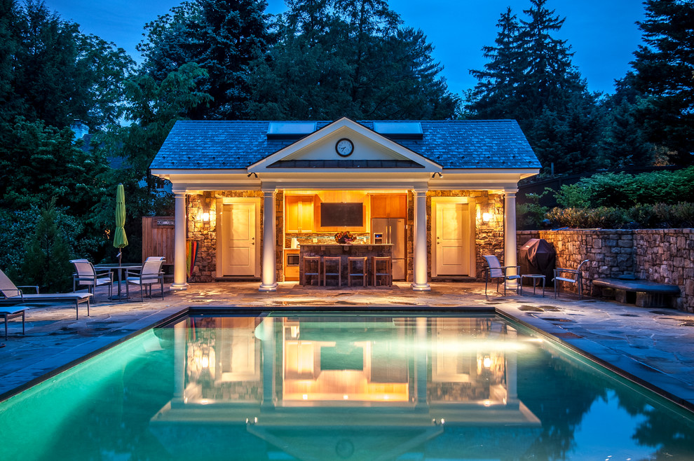 Inspiration for a traditional rectangular lengths swimming pool in DC Metro with a pool house and stamped concrete.