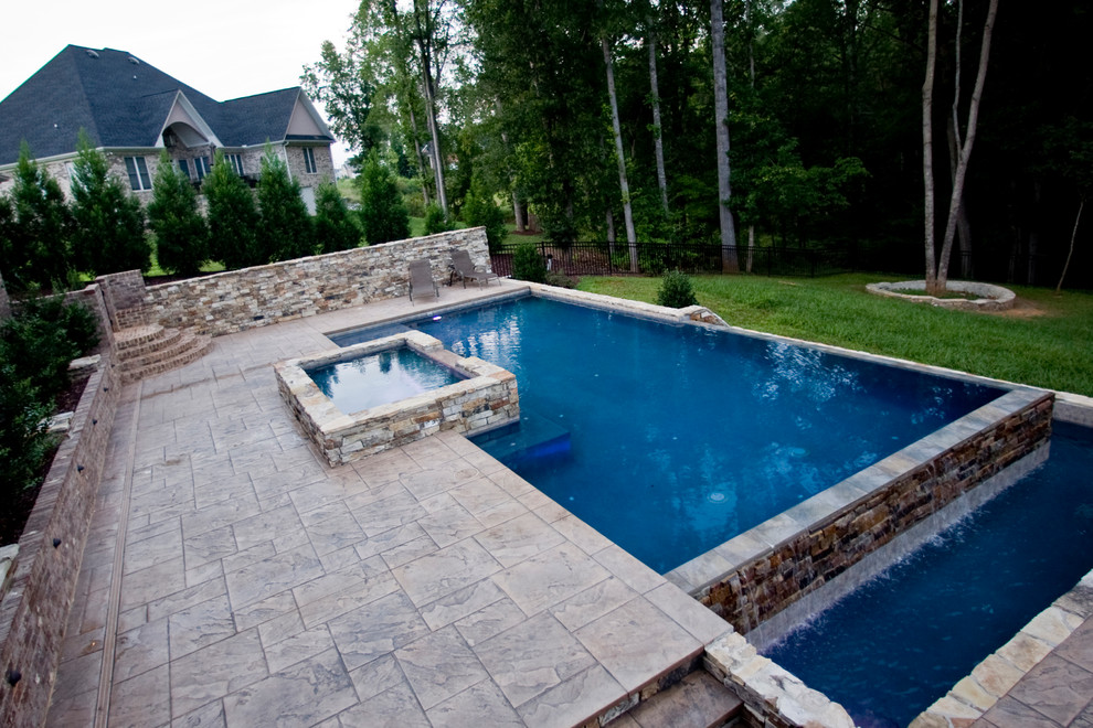 Design ideas for a medium sized traditional back custom shaped natural swimming pool in Raleigh with concrete slabs.