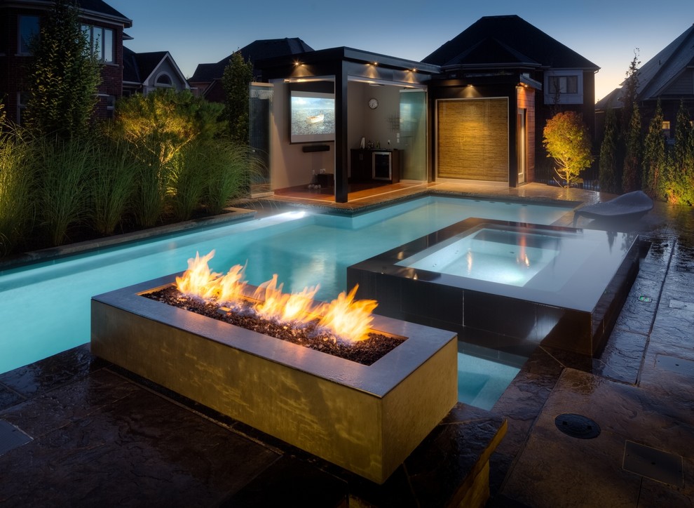 Hot tub - large contemporary backyard stone and custom-shaped hot tub idea in Toronto