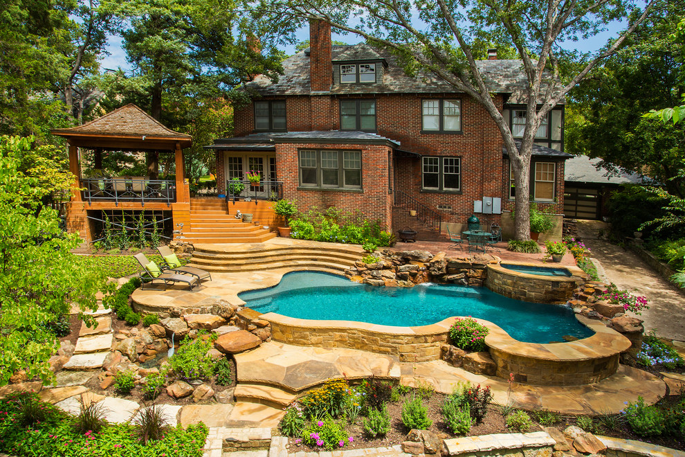 Medium sized rustic back custom shaped natural swimming pool in Dallas with natural stone paving.