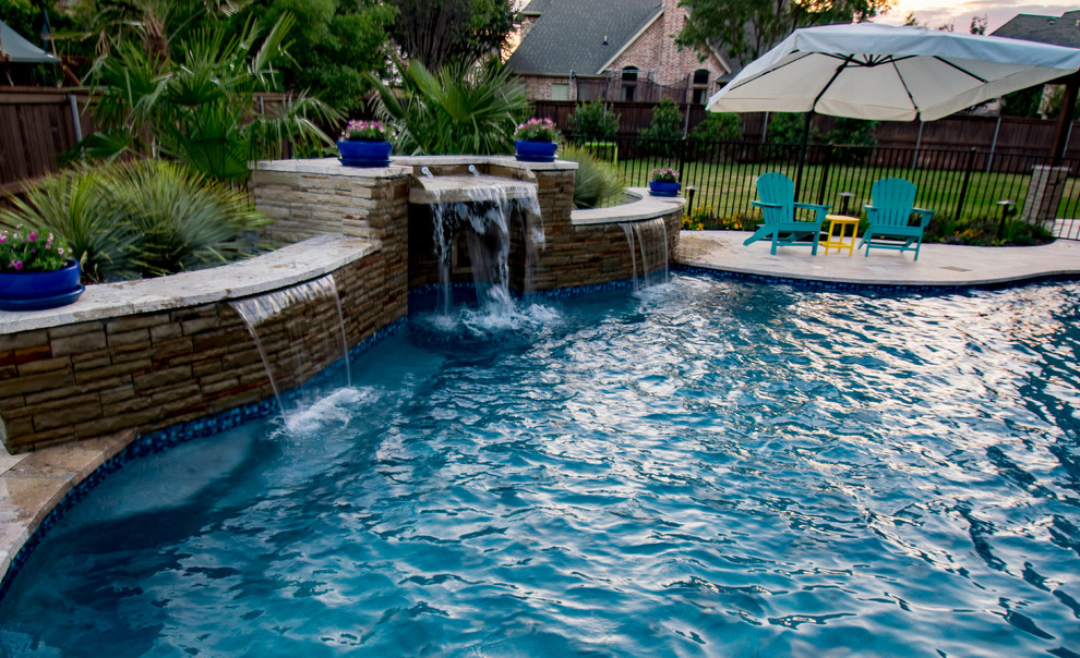 Photo of a large classic custom shaped swimming pool in Dallas with natural stone paving.