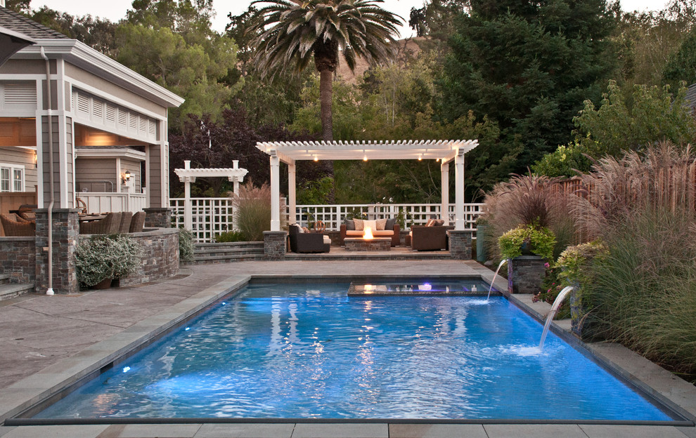 This is an example of a large rural back rectangular lengths swimming pool in San Francisco with a water feature.
