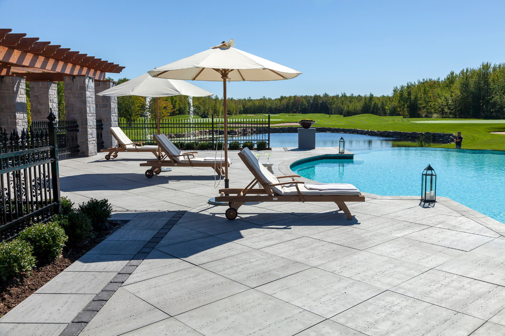 Example of a huge minimalist backyard custom-shaped infinity pool design in Philadelphia