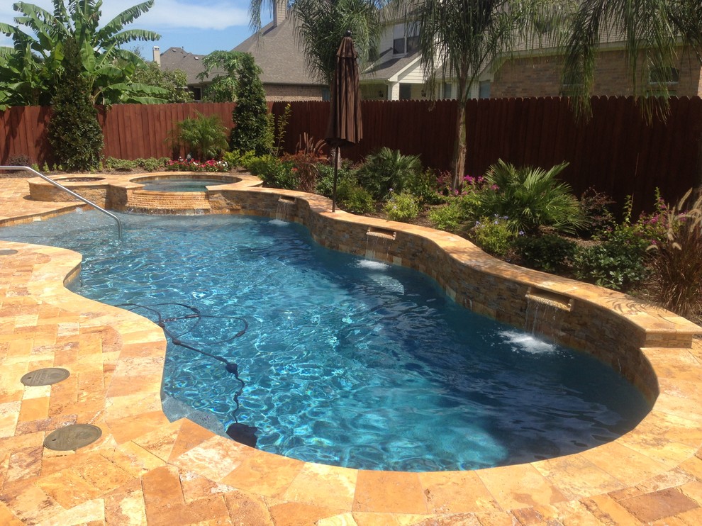 Medium sized world-inspired back custom shaped hot tub in Houston with concrete paving.