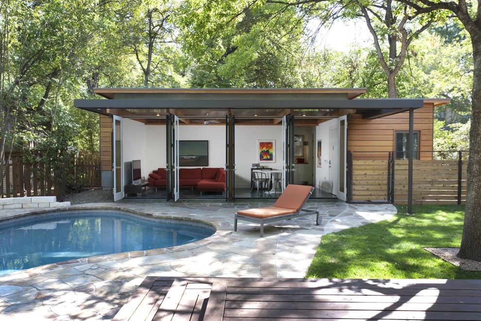 Pool house - contemporary custom-shaped pool house idea in Austin