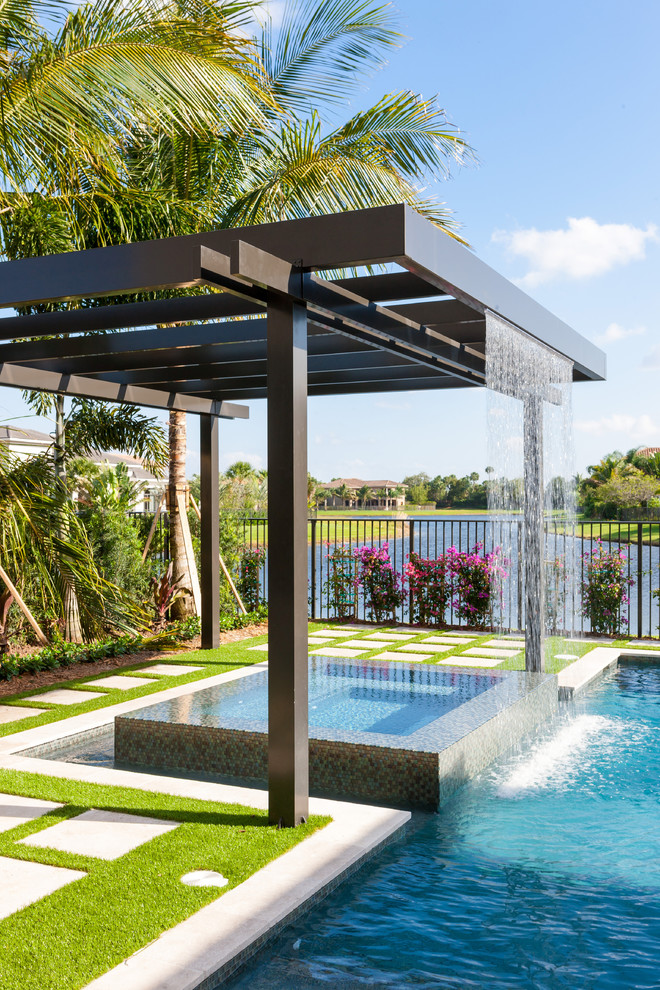 Photo of a contemporary swimming pool in Miami with a shelter.