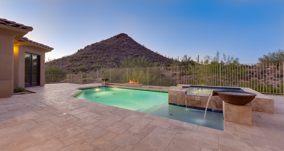 Large tuscan backyard tile and rectangular natural hot tub photo in Phoenix