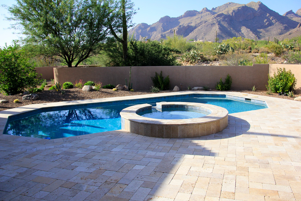 Example of a mid-sized tuscan backyard tile and custom-shaped lap hot tub design in Phoenix