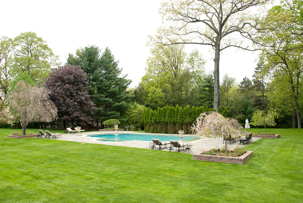 Large elegant backyard stone and custom-shaped pool photo in Los Angeles