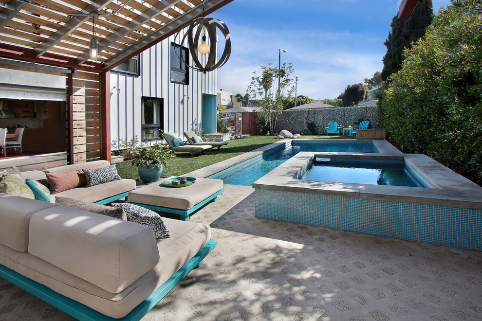 Inspiration for a contemporary swimming pool in Los Angeles with stamped concrete.