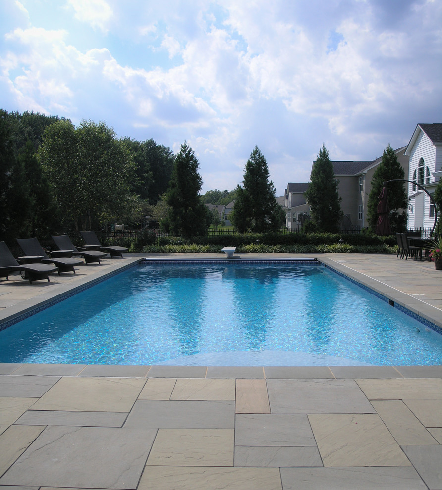 Design ideas for a large traditional back rectangular lengths hot tub in DC Metro with concrete paving.