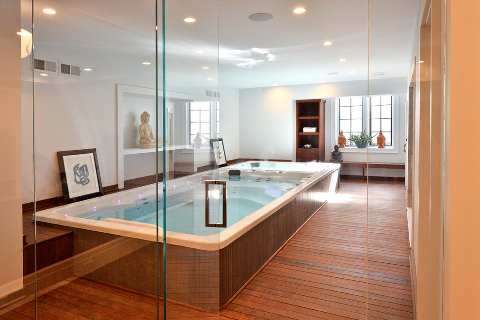 Example of a small classic indoor rectangular pool house design in New York with decking