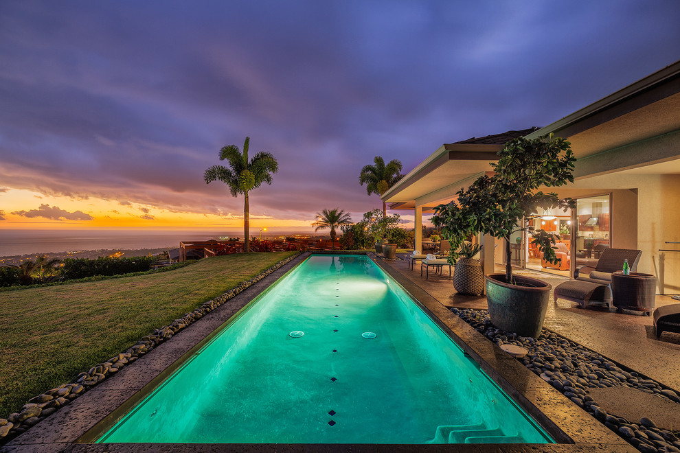 Medium sized traditional back rectangular lengths swimming pool in Hawaii with concrete slabs.
