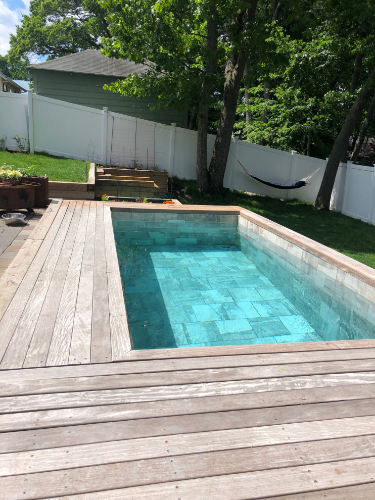 Small contemporary back rectangular natural hot tub in Boston with decking.