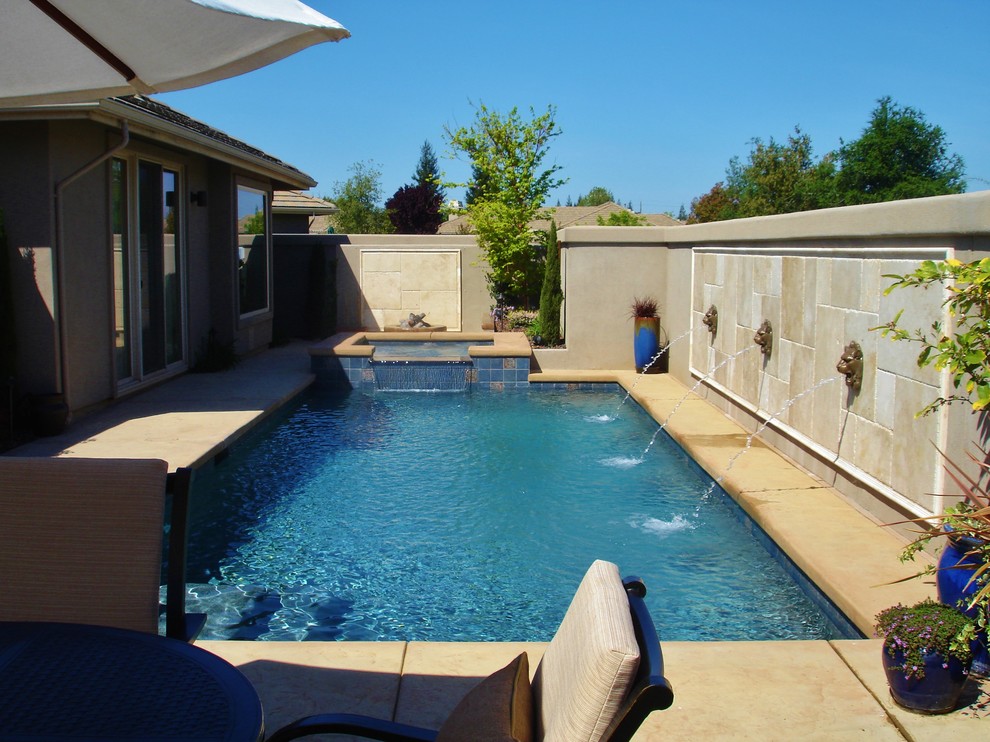 Foto de piscinas y jacuzzis actuales pequeños rectangulares en patio trasero con suelo de hormigón estampado