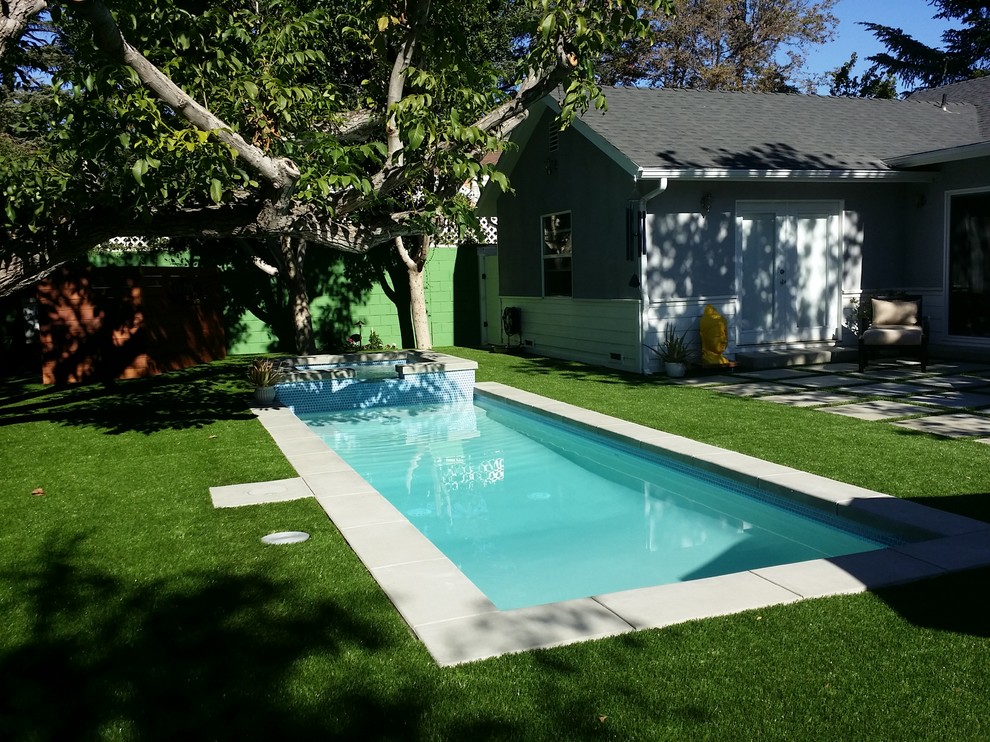 Design ideas for a small contemporary back rectangular natural hot tub in Los Angeles with concrete paving.