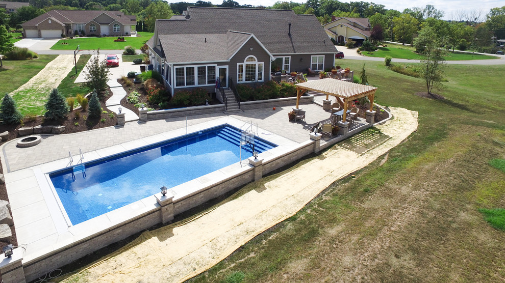 Inspiration for a large timeless backyard concrete and rectangular lap pool remodel in Chicago