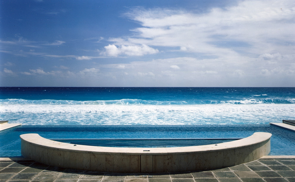 Example of an island style infinity pool design in Other