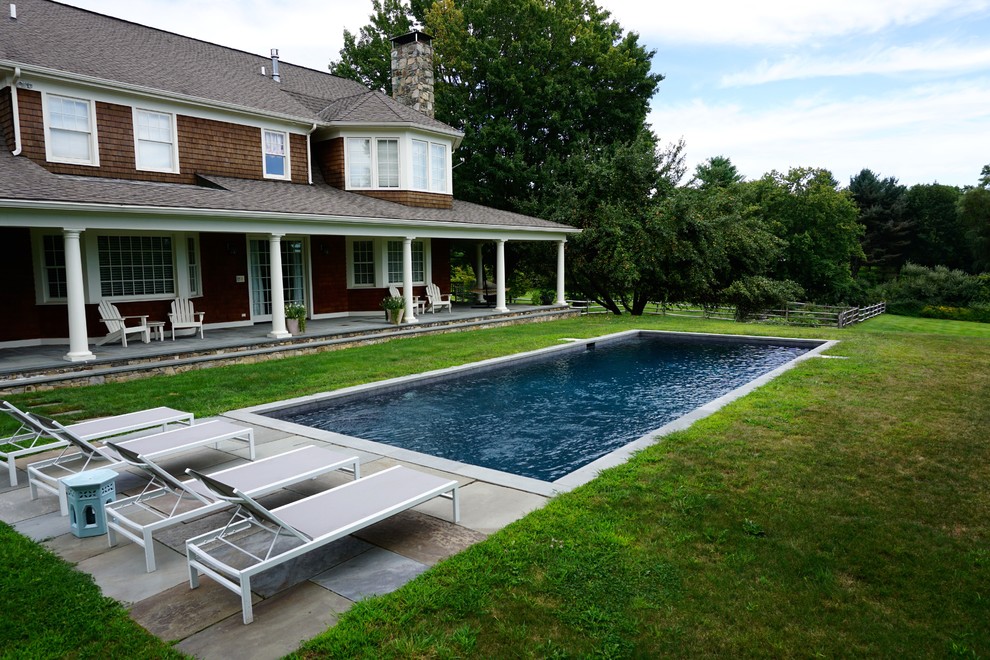 Mid-sized minimalist backyard concrete and rectangular lap pool photo in New York