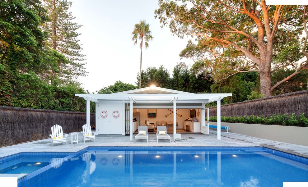 Стильный дизайн: большой наземный, прямоугольный бассейн на заднем дворе в классическом стиле с домиком у бассейна и покрытием из каменной брусчатки - последний тренд