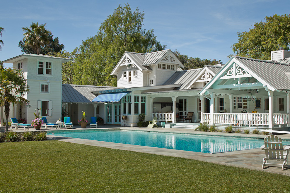This is an example of a large classic back rectangular lengths swimming pool in San Francisco with natural stone paving.