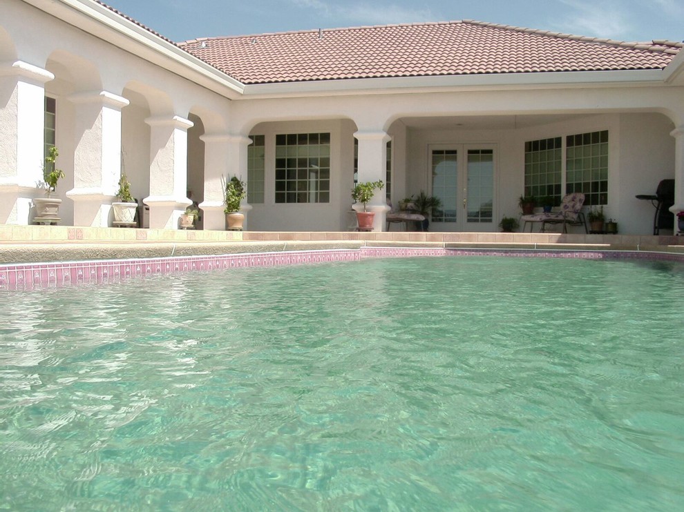 Inspiration for a medium sized traditional back custom shaped swimming pool in Boston with tiled flooring.
