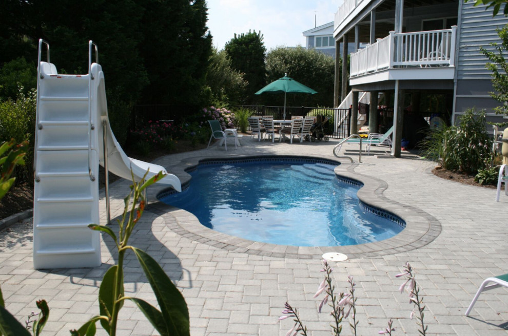 Inspiration for a small coastal backyard brick and custom-shaped water slide remodel in Boston