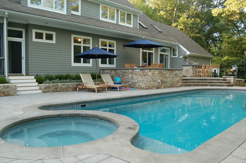 Design ideas for a medium sized classic back custom shaped swimming pool with natural stone paving.