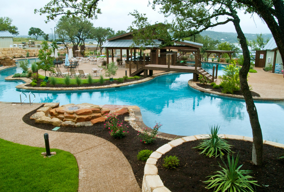 Pool house - huge rustic custom-shaped infinity pool house idea in Austin