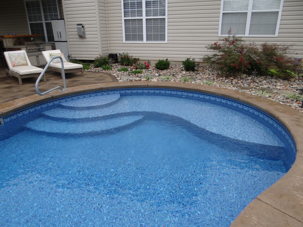 Diseño de piscina contemporánea de tamaño medio a medida en patio trasero con suelo de hormigón estampado