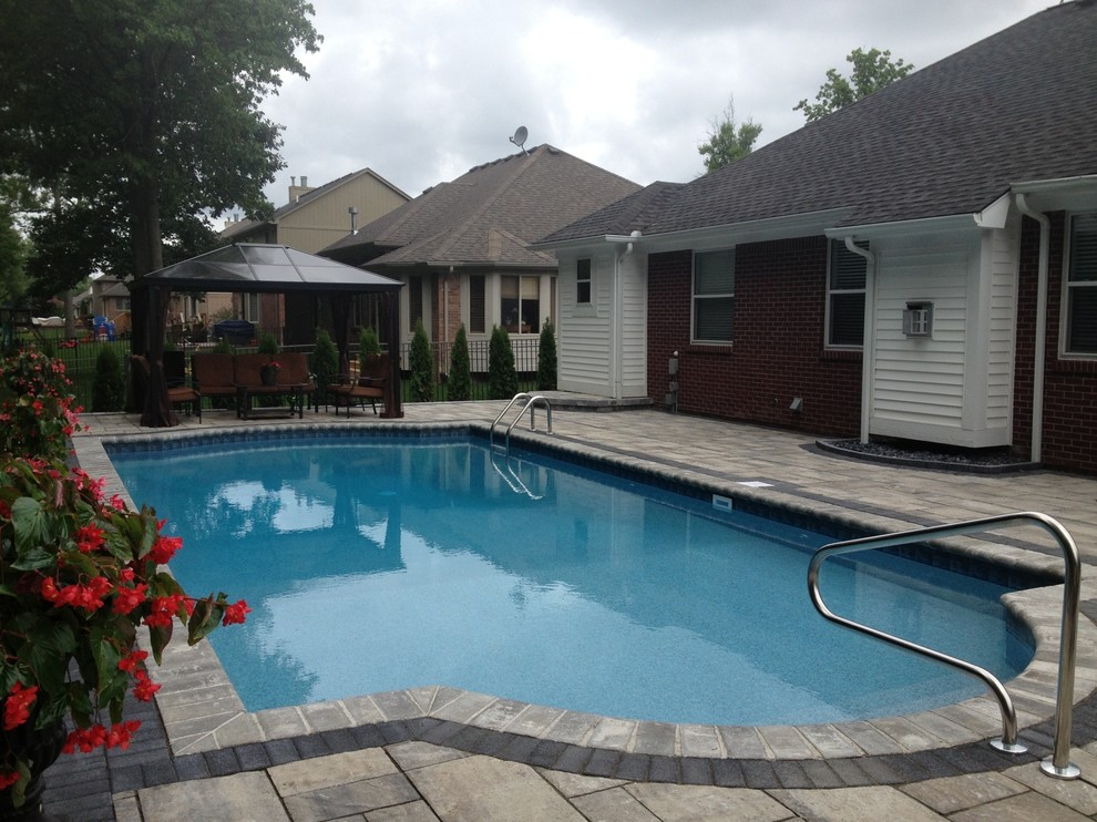 Foto de piscina clásica renovada a medida en patio trasero