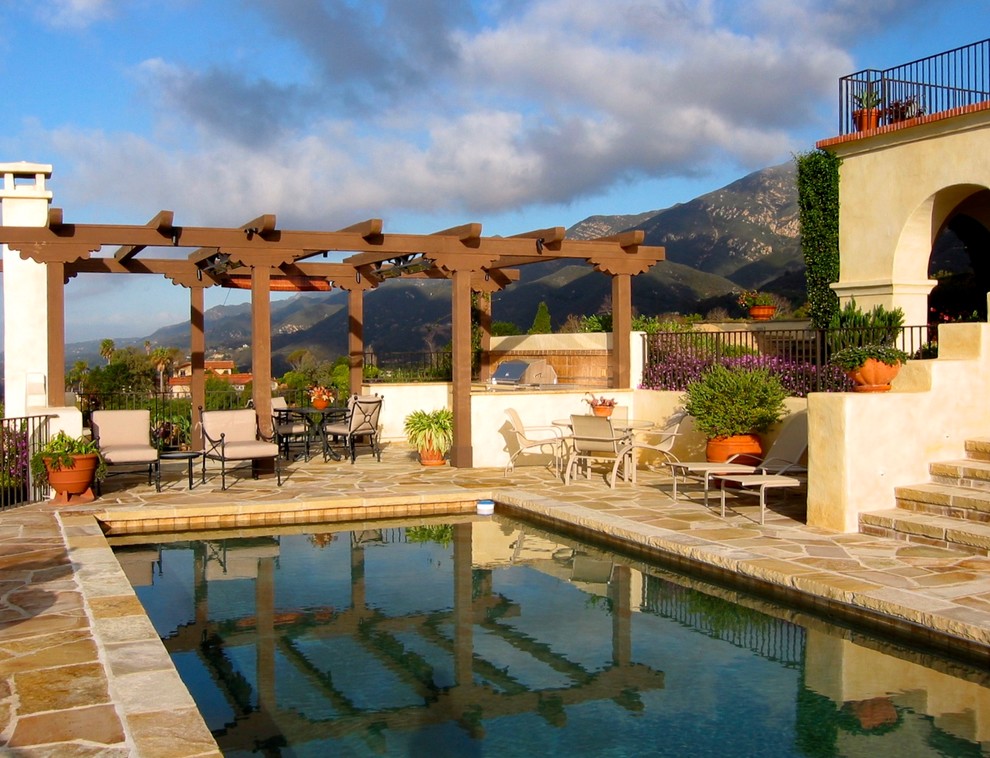 Large tuscan stone and rectangular pool photo in Santa Barbara