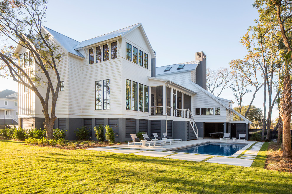 Foto de casa de la piscina y piscina contemporánea grande rectangular en patio trasero con adoquines de hormigón