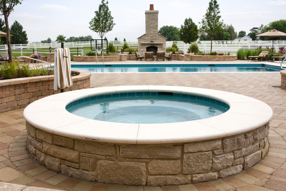 Medium sized classic back rectangular lengths hot tub in Chicago with concrete paving.