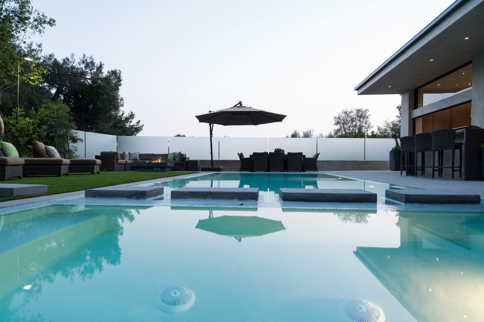 Inspiration for a large contemporary backyard rectangular lap pool remodel in Los Angeles
