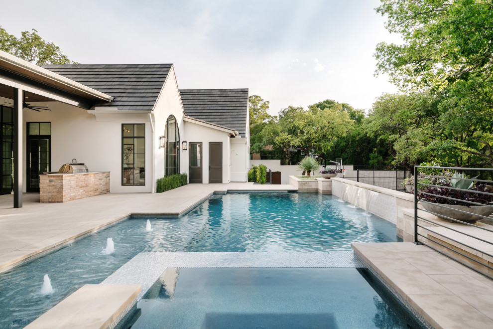 Inspiration for a large mediterranean back custom shaped swimming pool in Austin with a bbq area.