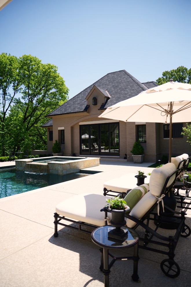 Ejemplo de casa de la piscina y piscina infinita tradicional renovada rectangular en patio trasero